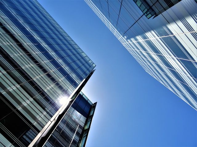 sunlight reflecting off windows of corporate skyscrapers